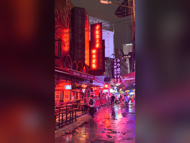 Bangkok neon bars wet street